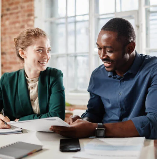 A collaborative team of professionals reviewing documents in a bright office, demonstrating the personalized client support found in premium IT and BPO services.